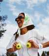 Wearing white and green tennis set while being playful
