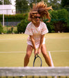 Women feeling cool and free wearing tennis dress on the court