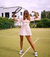 Strong athletic but cute women wearing tennis dress